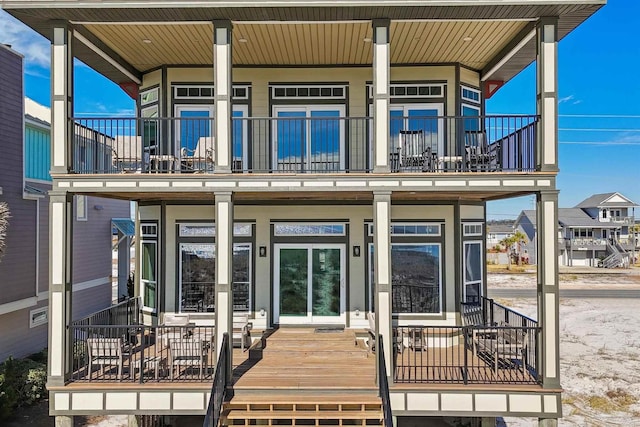 exterior space featuring covered porch and a balcony