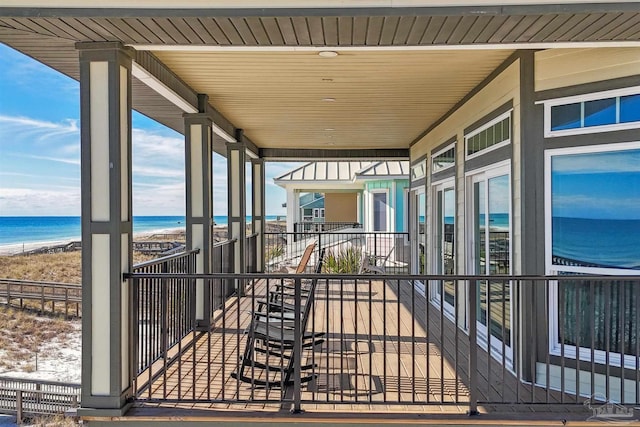 exterior space with a water view and a beach view