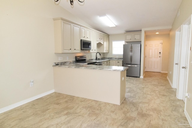 7101 Joy St Unit J5, Pensacola, FL 32504 - kitchen with appliances with stainless steel finishes, a sink, a peninsula, cream cabinetry, and light countertops
