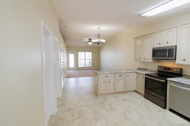 7101 Joy St Unit J5, Pensacola, FL 32504 - kitchen with stainless steel appliances, a peninsula, a chandelier, open floor plan, and pendant lighting