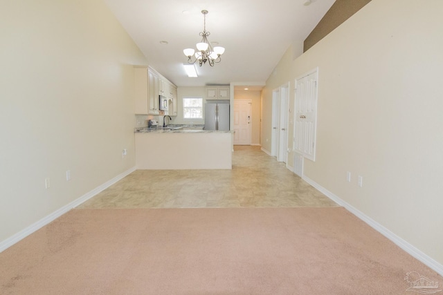 7101 Joy St Unit J5, Pensacola, FL 32504 - unfurnished living room with a chandelier, a sink, and baseboards