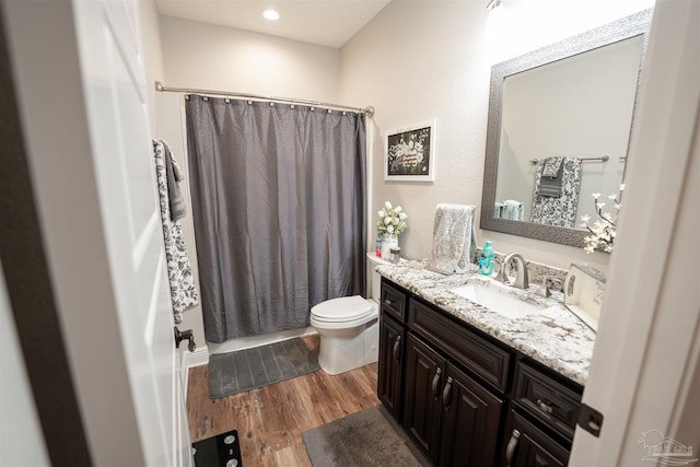 bathroom with vanity, hardwood / wood-style floors, and toilet