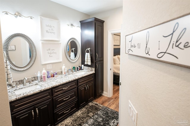 bathroom with vanity and wood-type flooring