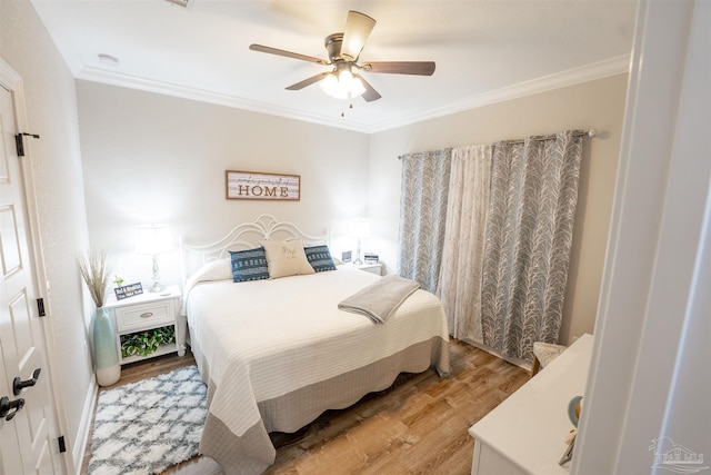 bedroom featuring crown molding, ceiling fan, and light wood-type flooring