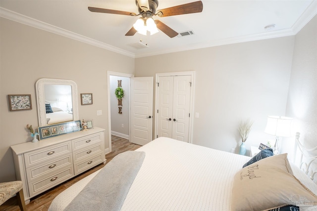 bedroom featuring wood-type flooring and crown molding