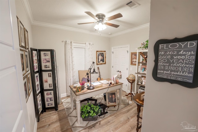 office area with light hardwood / wood-style flooring, ornamental molding, and ceiling fan