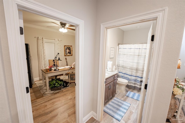 bathroom with toilet, ornamental molding, vanity, curtained shower, and hardwood / wood-style floors