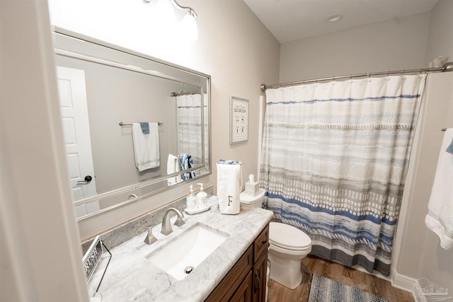 bathroom with vanity, hardwood / wood-style flooring, a shower with curtain, and toilet