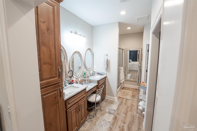 bathroom featuring hardwood / wood-style flooring and vanity