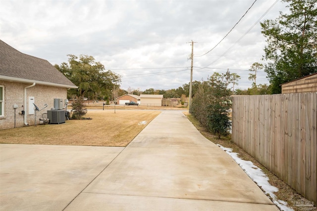 view of yard with a patio and central air condition unit