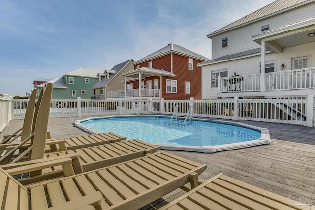 view of swimming pool featuring a wooden deck