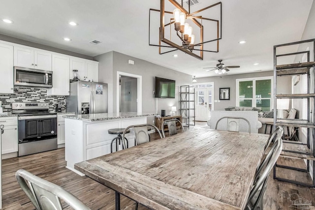 dining space featuring ceiling fan and dark hardwood / wood-style floors