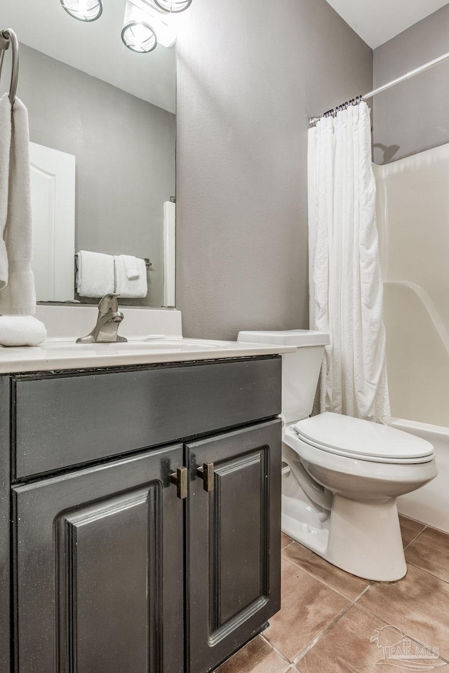 full bathroom with tile patterned flooring, vanity, toilet, and shower / tub combo with curtain