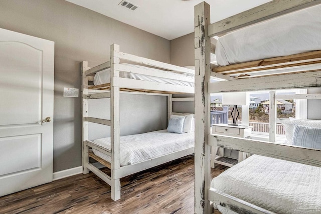 bedroom with dark hardwood / wood-style flooring