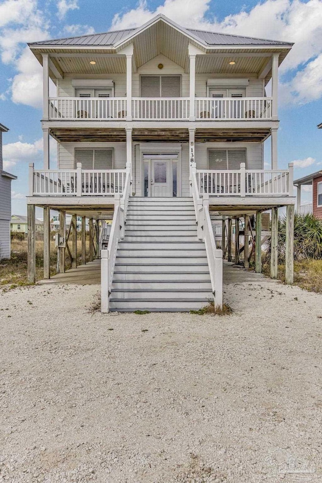 coastal home featuring a carport and covered porch