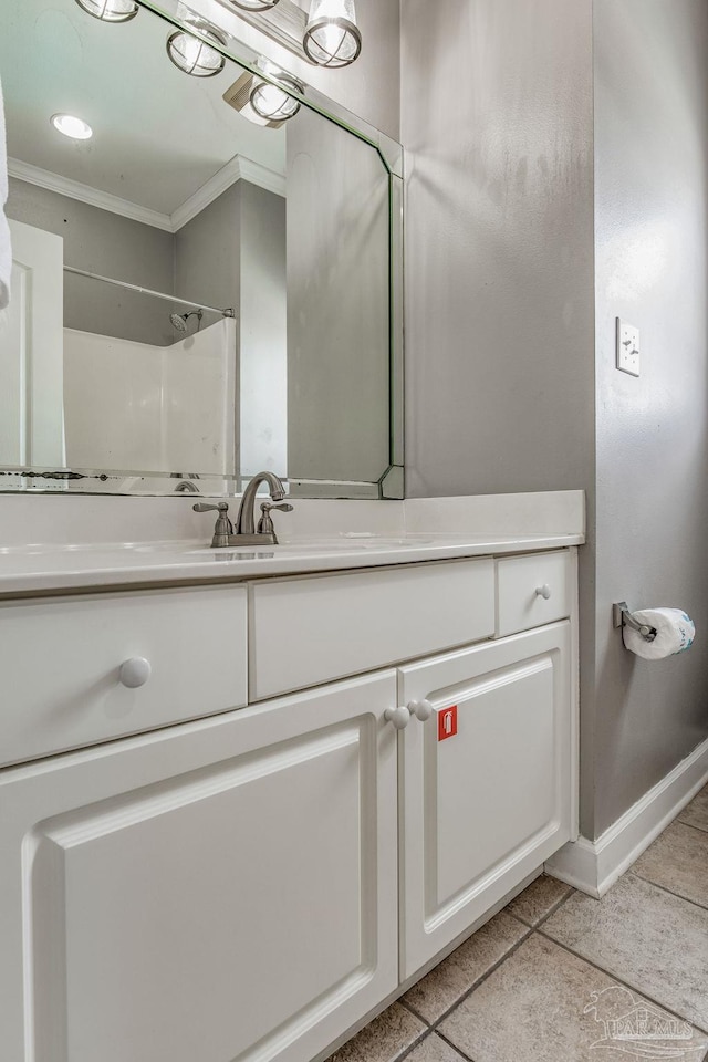 bathroom with vanity, tile patterned floors, ornamental molding, and walk in shower