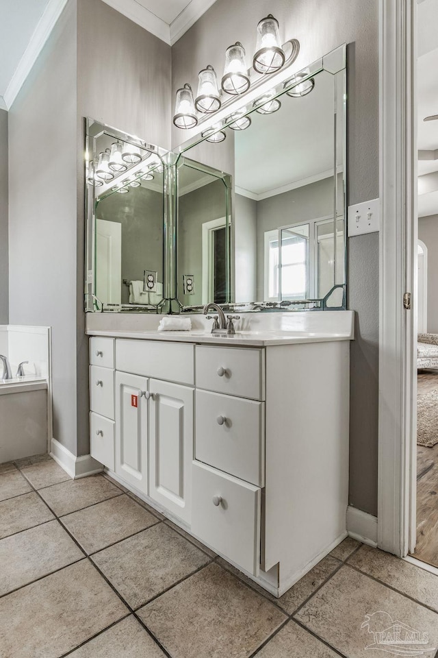 bathroom featuring crown molding, vanity, and a tub to relax in