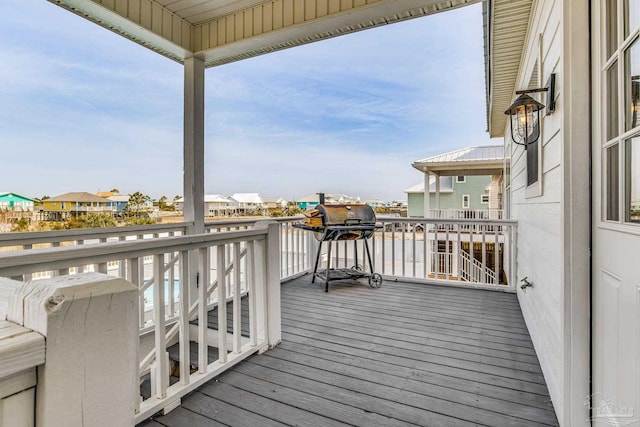 wooden deck with a grill