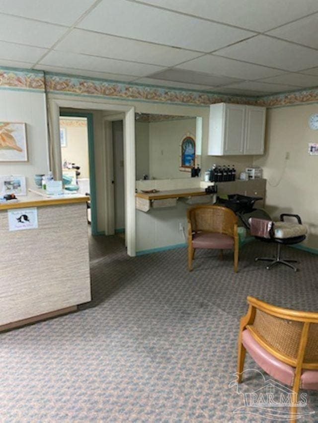 kitchen featuring carpet floors and a drop ceiling