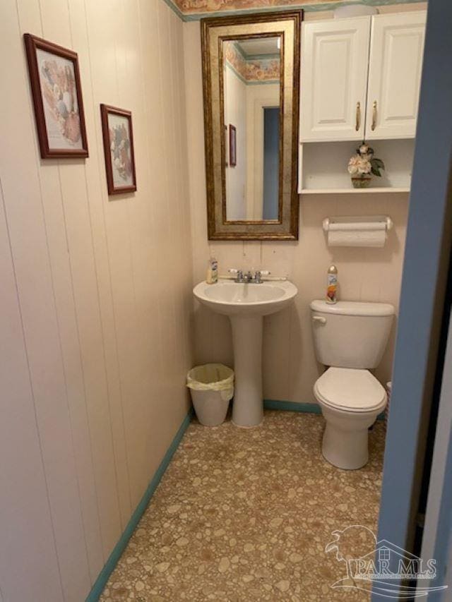 half bath with a sink and toilet