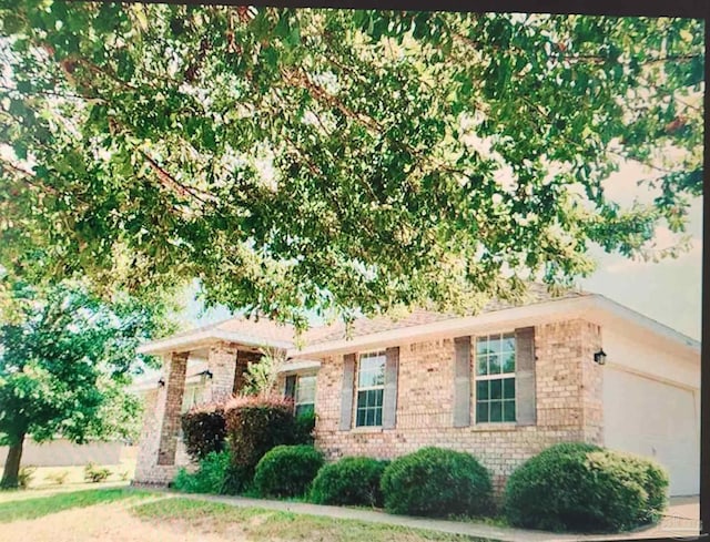 2441 Pine Forest Rd, Pensacola, FL 32533 - ranch-style home with brick siding and a garage