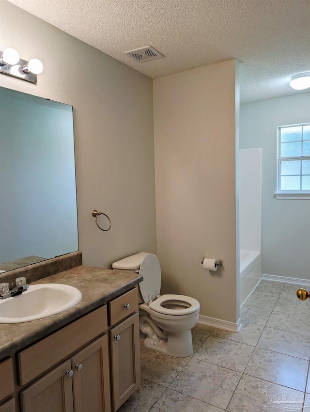 2441 Pine Forest Rd, Pensacola, FL 32533 - full bathroom featuring toilet, a textured ceiling, vanity, tile patterned floors, and baseboards