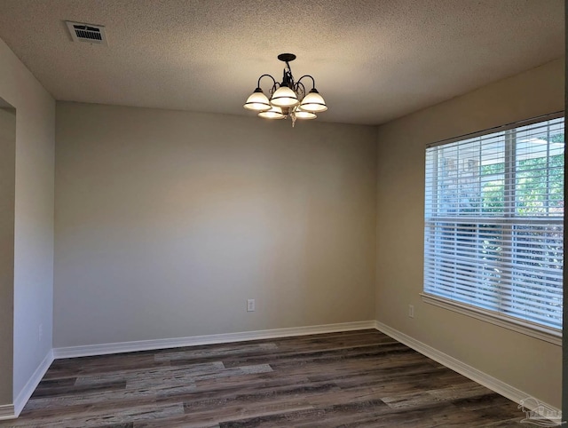 2441 Pine Forest Rd, Pensacola, FL 32533 - spare room with dark wood finished floors, a textured ceiling, a chandelier, and baseboards