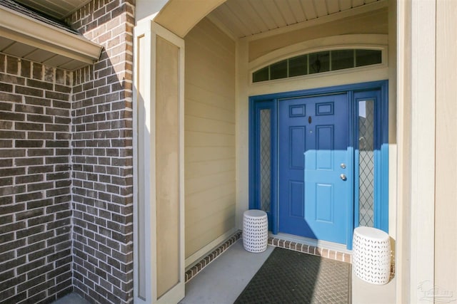 property entrance with brick siding