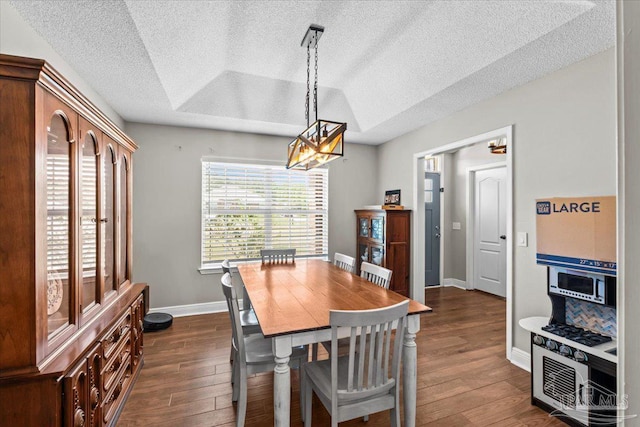 2863 Wallace Lake Rd, Pace, FL 32571 - dining space with a textured ceiling, dark wood finished floors, baseboards, and an inviting chandelier