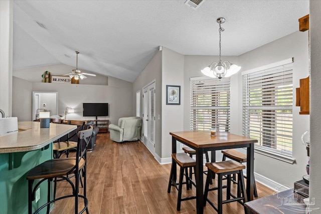2863 Wallace Lake Rd, Pace, FL 32571 - dining space with baseboards, wood finished floors, lofted ceiling, and ceiling fan with notable chandelier