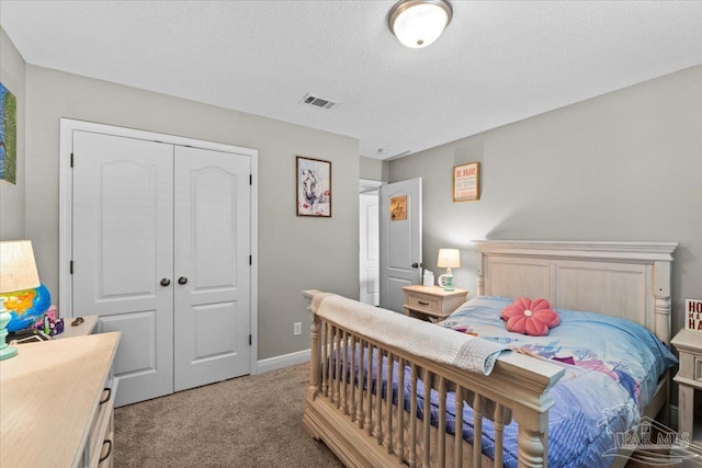 2863 Wallace Lake Rd, Pace, FL 32571 - bedroom with light colored carpet, a textured ceiling, baseboards, visible vents, and a closet