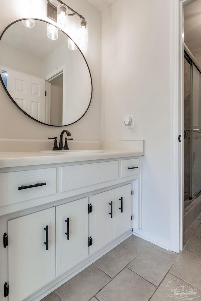 bathroom with vanity, a shower stall, and tile patterned floors