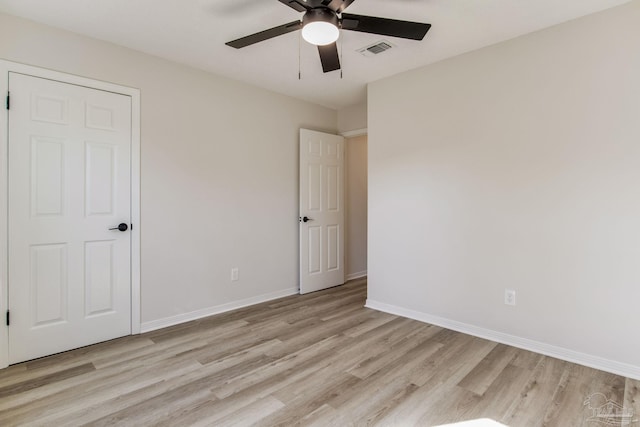 unfurnished bedroom with light wood-style floors, visible vents, baseboards, and a ceiling fan