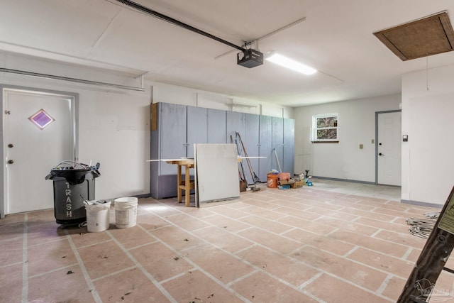 garage with baseboards and a garage door opener