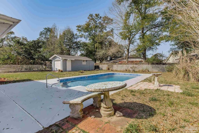 view of swimming pool featuring an outbuilding, a patio area, a fenced backyard, and a fenced in pool