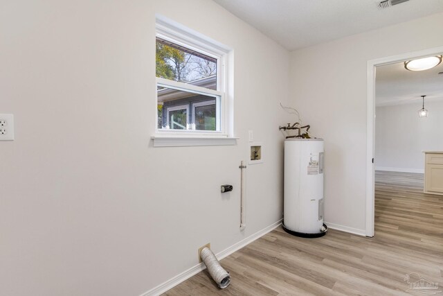 washroom with electric water heater, laundry area, washer hookup, baseboards, and light wood-style floors