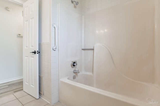 bathroom with shower / bathing tub combination, visible vents, and tile patterned floors