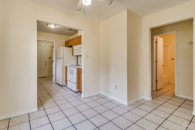 kitchen featuring light tile patterned floors, white appliances, and ceiling fan