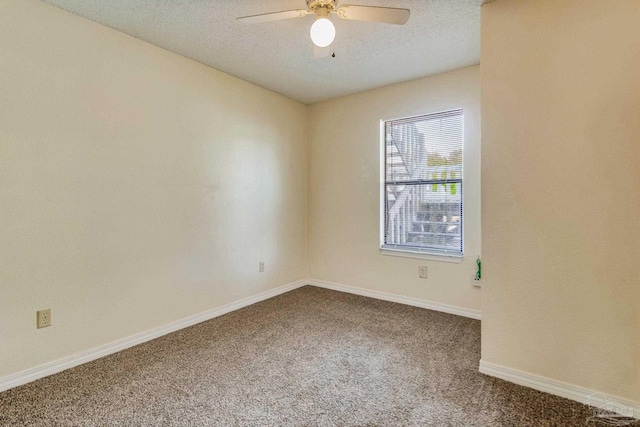 empty room featuring ceiling fan, carpet, and a textured ceiling