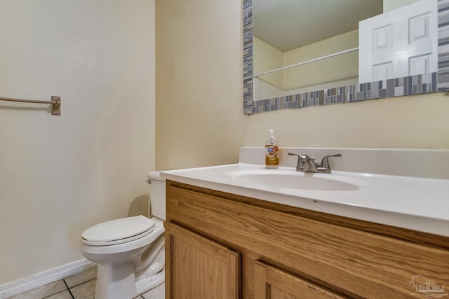 bathroom featuring tile patterned floors, vanity, a textured ceiling, and toilet