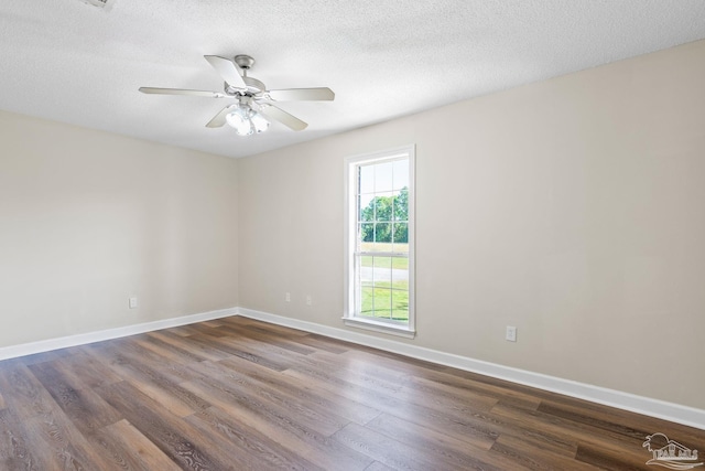 unfurnished room with a textured ceiling, dark hardwood / wood-style floors, and ceiling fan