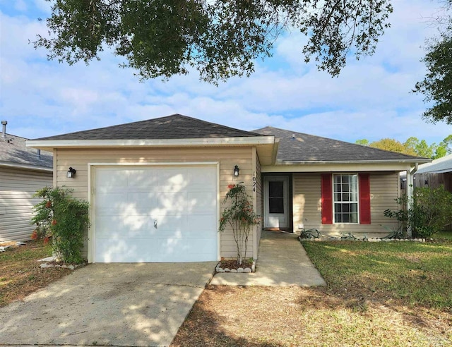 single story home featuring a front lawn and a garage