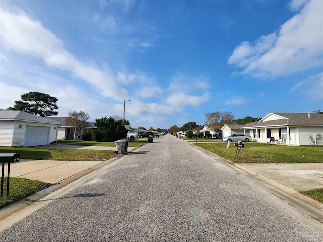 view of road featuring a residential view, curbs, and street lights