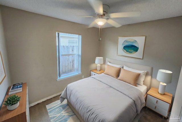 bedroom featuring carpet floors, ceiling fan, a textured ceiling, and baseboards