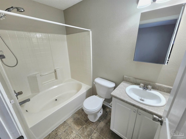 full bathroom with a textured wall, shower / washtub combination, vanity, and toilet