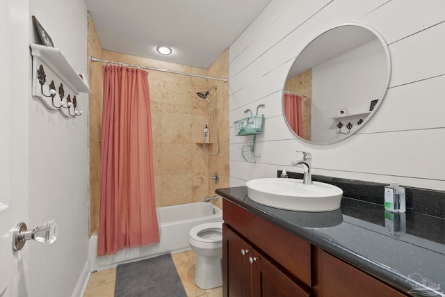 full bathroom featuring tile patterned floors, vanity, shower / tub combo with curtain, toilet, and wood walls