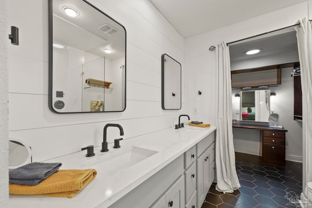 bathroom featuring tile patterned flooring and vanity