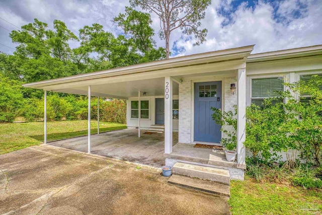 property entrance with a lawn