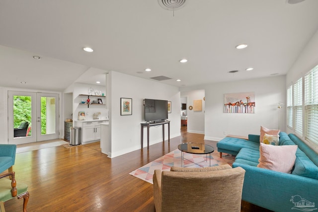 living room with hardwood / wood-style flooring, a healthy amount of sunlight, and french doors