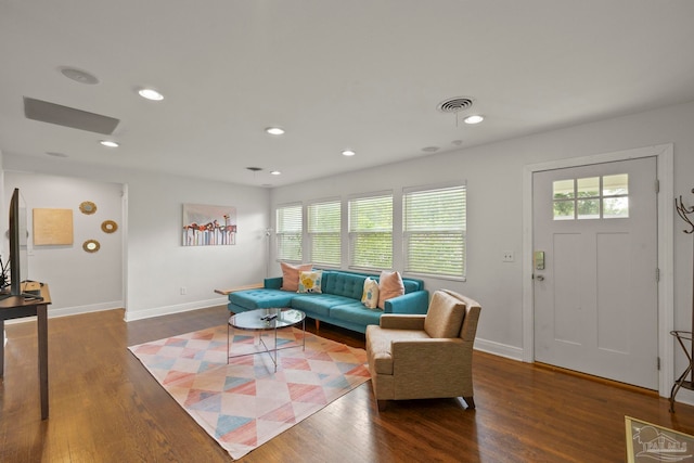 living room featuring plenty of natural light and dark wood-type flooring